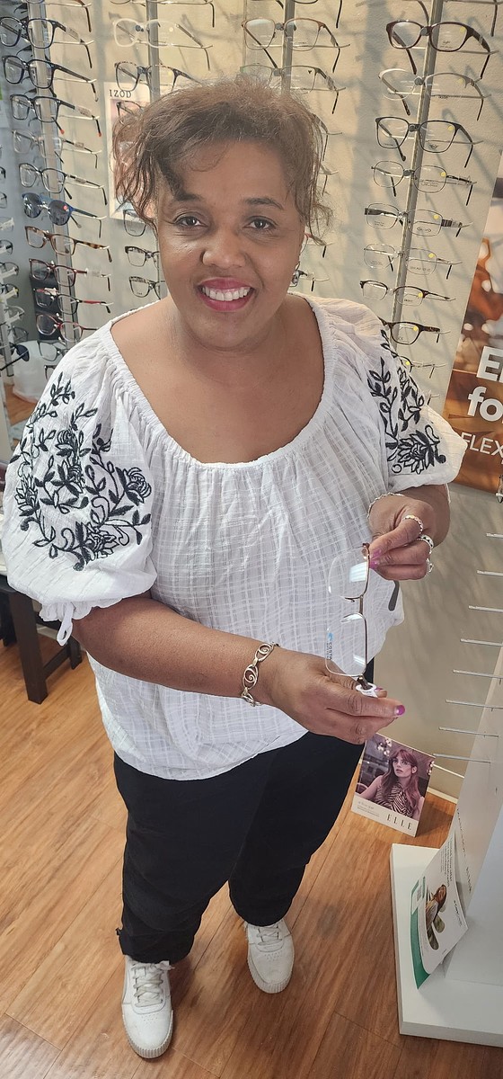 Andrea Baker Optical staff member inspecting a customer's eyeglass frame before fitting new prescription lenses in Burnet, TX