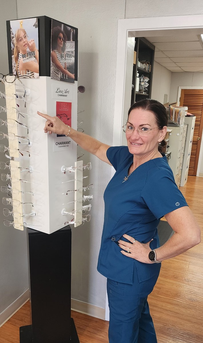 Andrea Baker guiding a customer through the frame collection during a personal fitting consultation in Burnet, TX